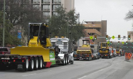 Parade of construction equipment down Commerce St.